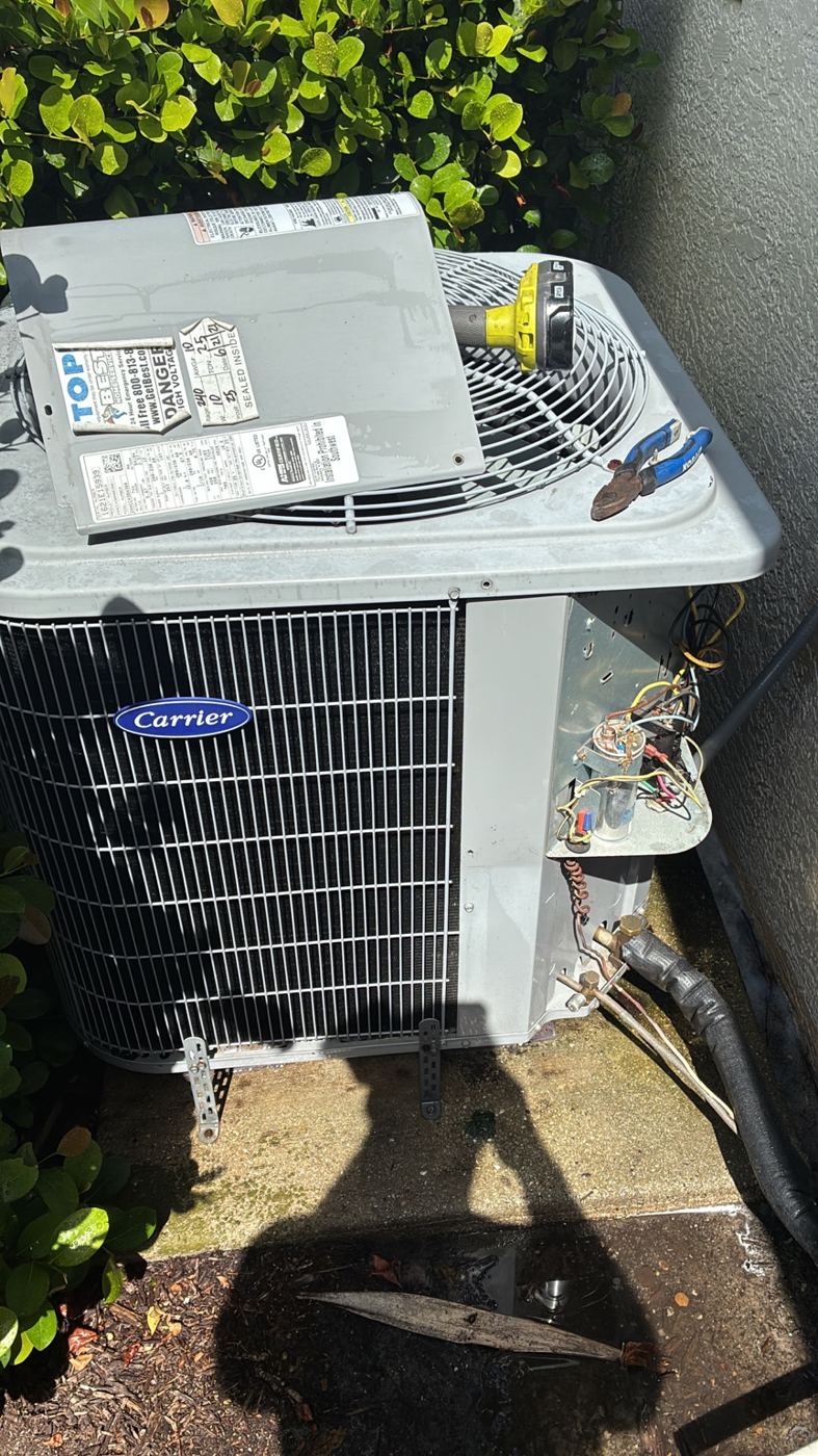Outdoor Carrier AC unit opened during maintenance in Naples
