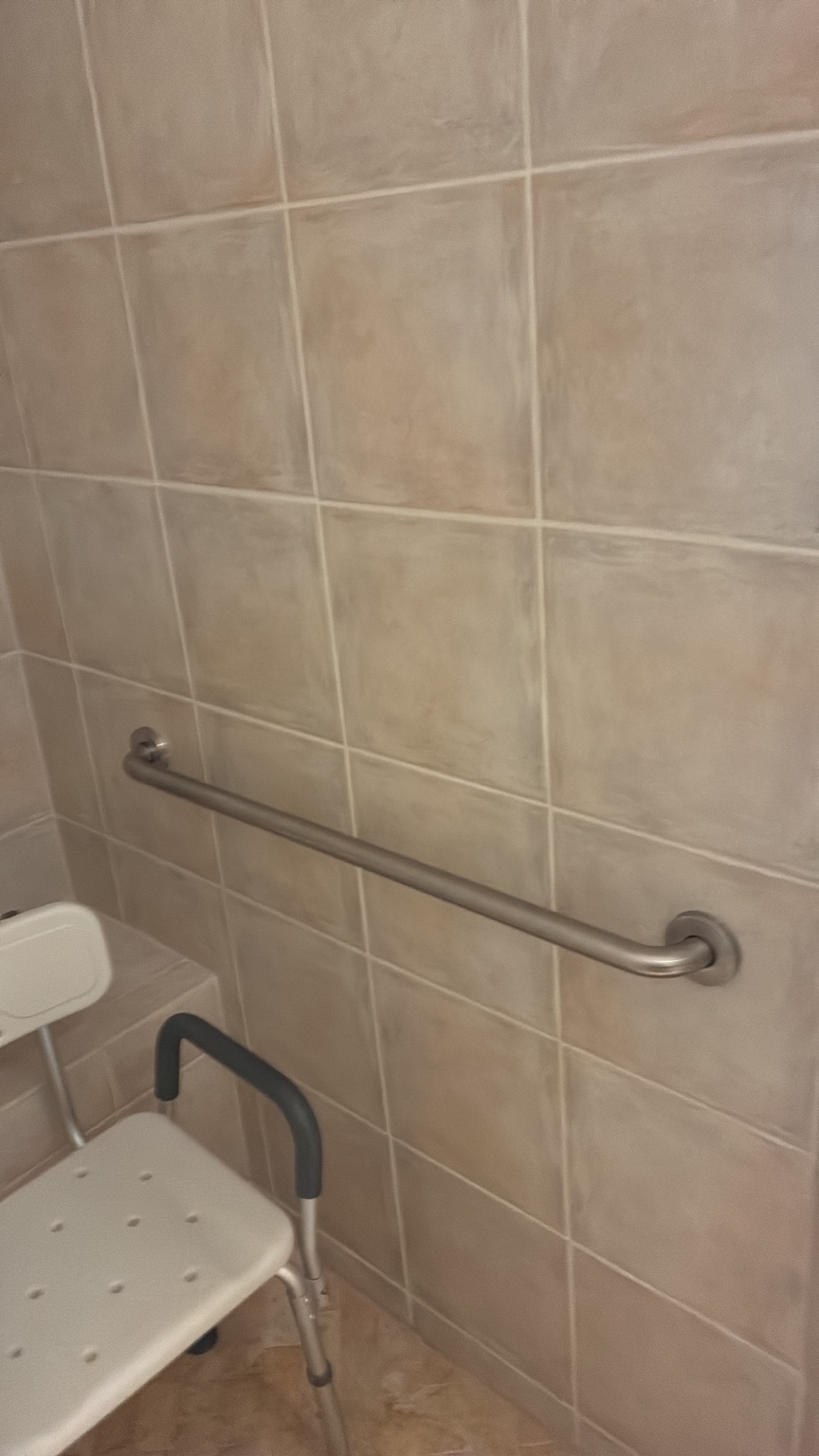 Grab bar installed on tiled shower wall